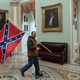 A supporter of President Donald Trump carries a Confederate flag during the insurrection of the US Capitol on January 6, 2021, in Washington, DC. -